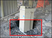 Water heater installed on an unstable timber base - and on a sloping surface.