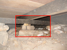 Sub floor has low clearance. Bearing has no structural integrity on rocks. No ant caps to stop termite invasion.